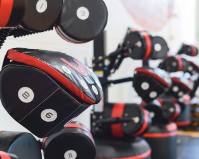 A row of black and red weights neatly arranged in a gym setting in Denver, CO