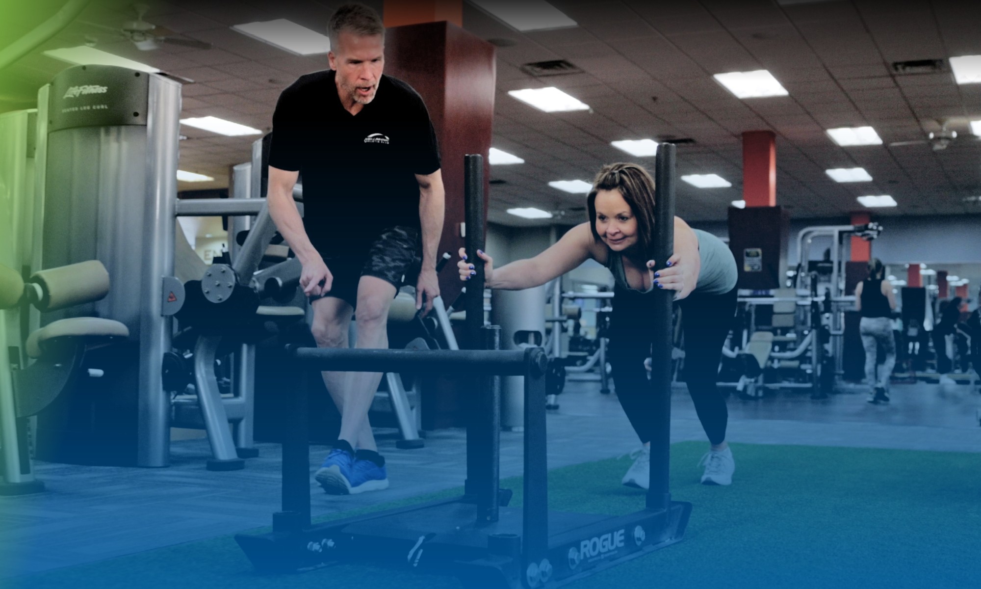 A woman being trained by a personal trainer at Colorado Athletic Club