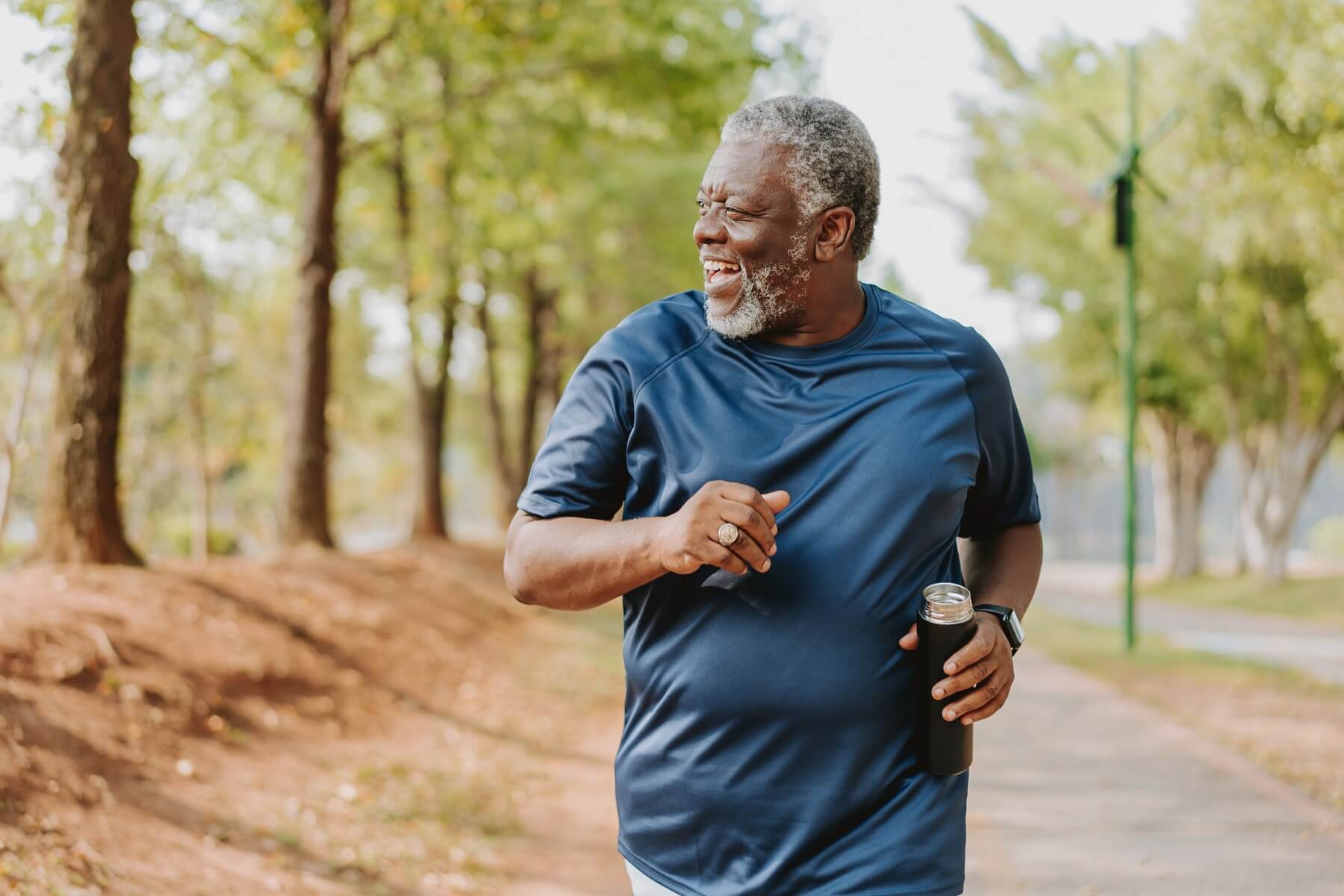 An older man runs in a South Denver park, showcasing that it's never too late to get in shape