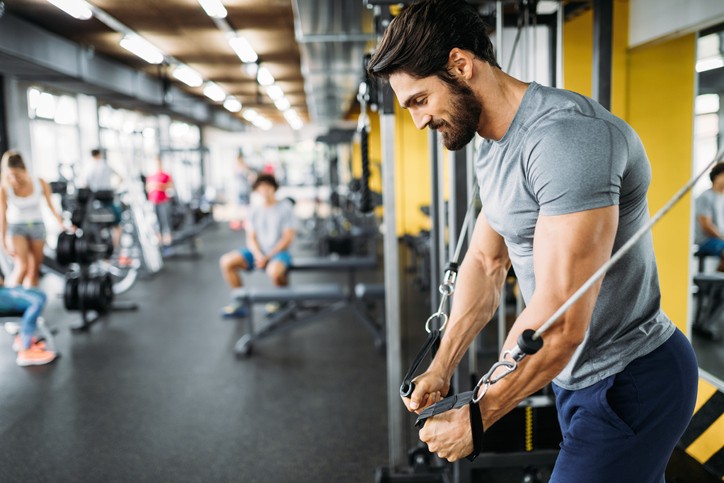 A man performs an exercise as a part of the ultimate arms and chest workout plan in South Denver