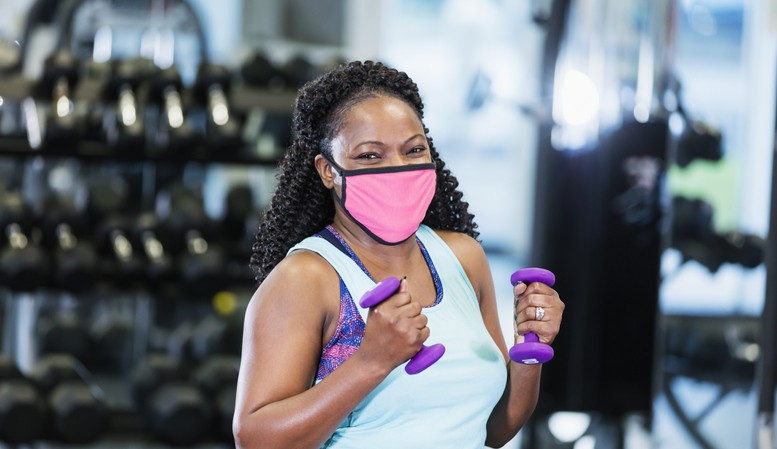 African-American woman at the gym, wearing face mask