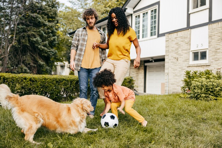 Family with young kid outside exercising