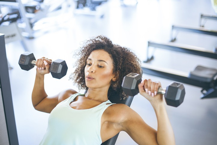 Women doing chestpress with dumbells , CO