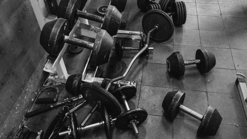Mature couple smiling while working out together in black and white at Wellbridge