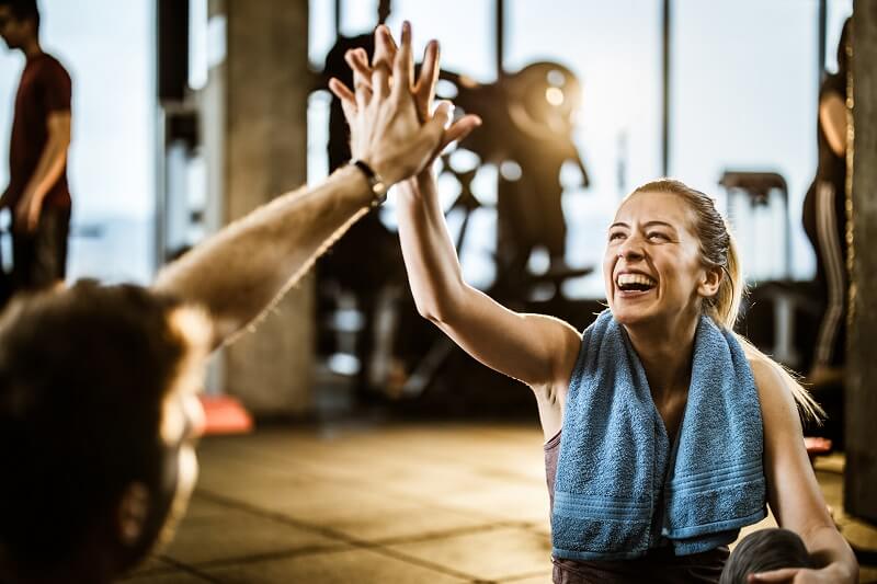 high fiving at athletic club