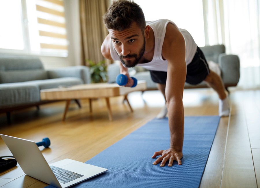 The man doing one hand pushups in home