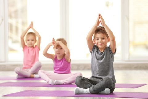 A group of kids practicing yoga at Colorado Athletic Club 