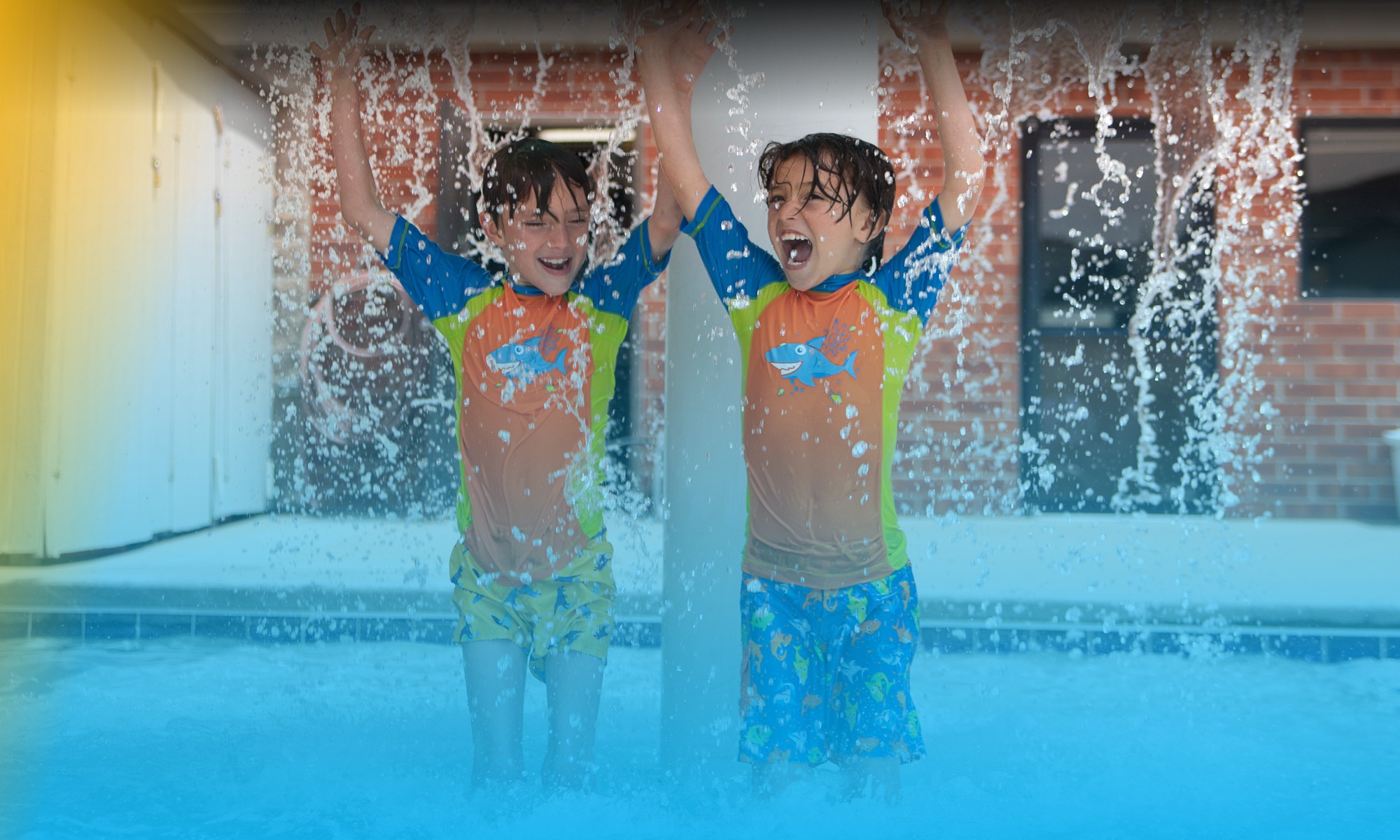 Two kids playing in a pool at Colorado Athletic Club