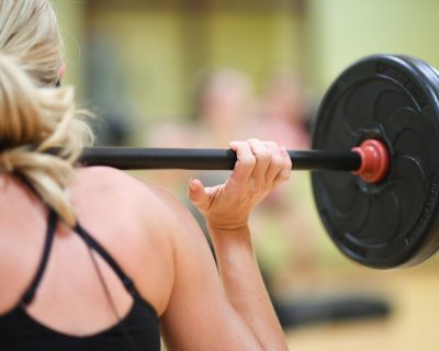 Woman Doing Weighted Squats | Colorado Athletic Club - Flatirons