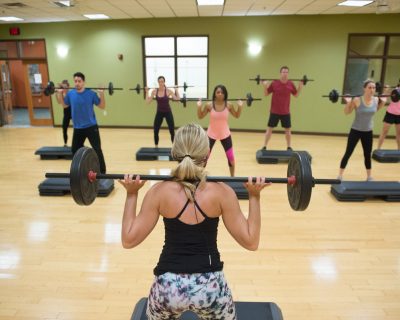 Instructor Leading Class in Weighted Squats