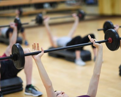 Group Fitness Class Doing Bench Press | Colorado Athletic Club - Flatirons