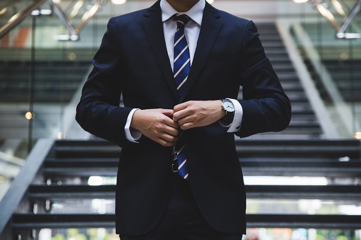 A corporate man in a suit going to Colorado Athletic Club DTC.