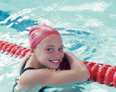 A young girl enjoying a swim in a pool, promoting kids' swimming programs in Albuquerque, NM