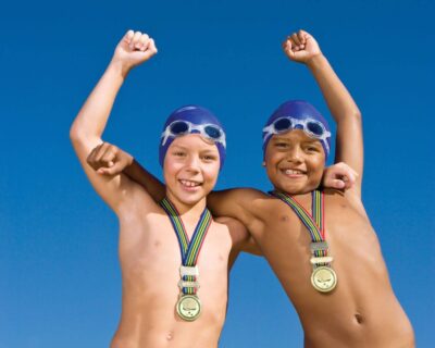 Two boys in swim caps representing the swim team in Albuquerque, NM
