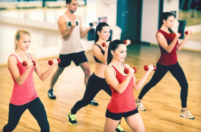 A Group of People Lifting Dumbbells at a Fitness Center in CO