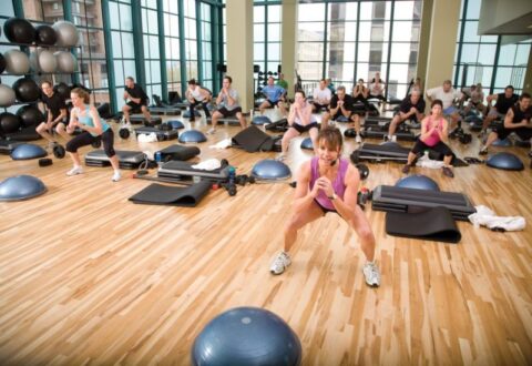 A group of people exercising together in a fitness class in South Denver