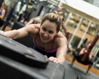 woman pushing sled Denver Colorado Athletic Club