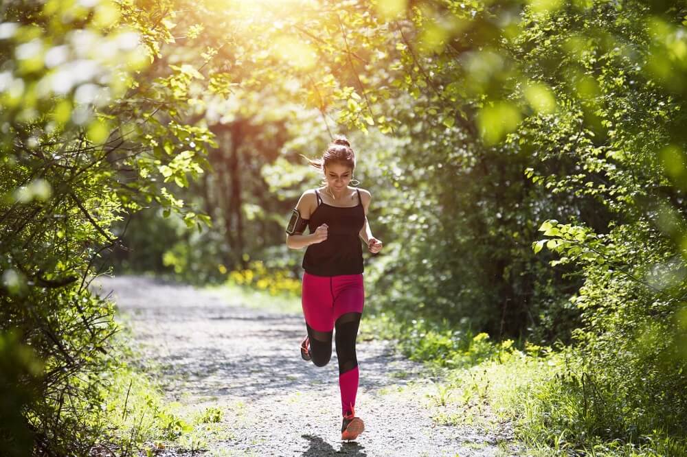 A running women promoting a quote May is national physical fitness and sports month in South Denver